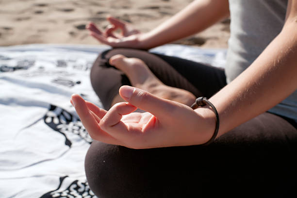 istock Woman practicing yoga on the beach 519935247