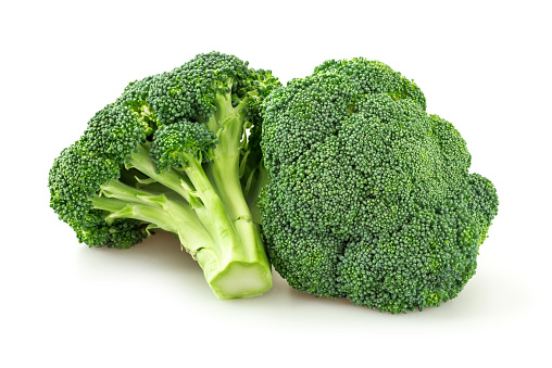 Picture of fresh cut broccoli. Broccoli is brightly illuminated and photographed against white background.