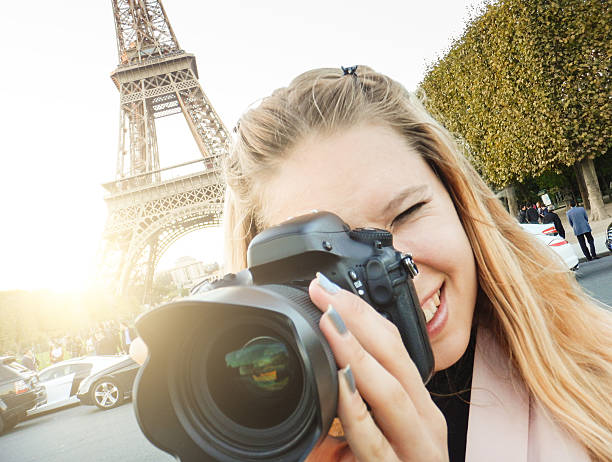 istock woman self photographing on paris ith the tour eiffel 519937281