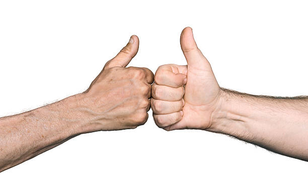 istock Two men bumping fists with thumbs up 519937681