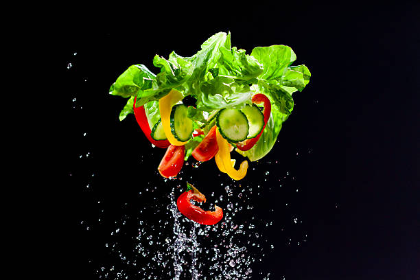 istock Fresh vegetables and water thrown in the air 519937961