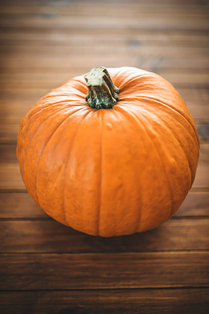istock halloween pumpkin on rustic wood 519939493