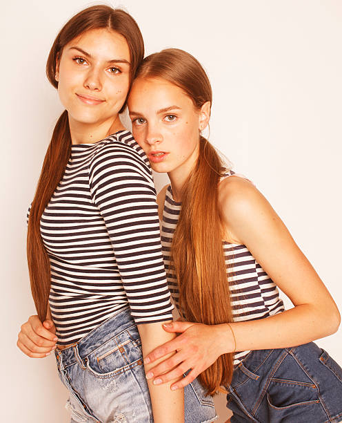 istock two cute teenagers having fun together isolated on white 519954406