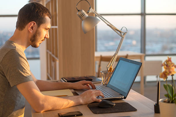 istock business man working on laptop at desk in office 519959526