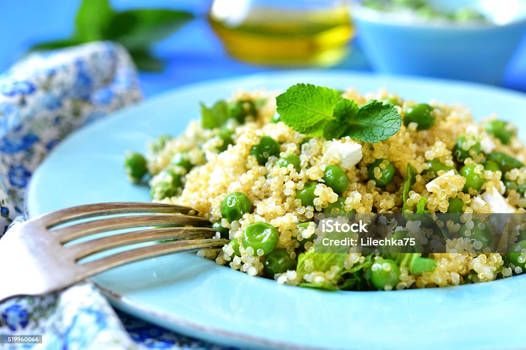 Quinoa salad with green pea,feta and mint. Quinoa salad with green pea,feta and mint on a blue background. Quinoa Stock Photo