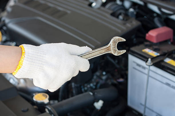 istock Hand with wrench repairing car engine 519960988