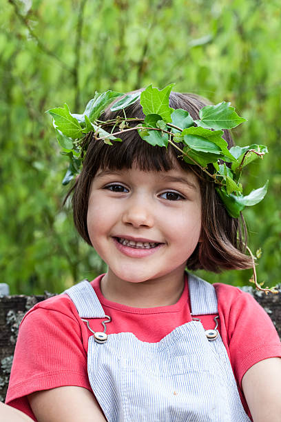 cute young kid with ivy leaves crown looking like angel