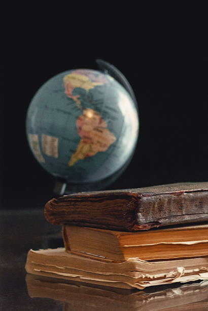 istock Old books and globe on the desk with black backgound 519962416