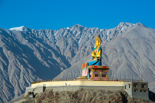 Huge statue of Maitreya Buddha (the future Buddha) near Diskit Monastery in the hidden Nubra Valley facing down the Shyok River towards Pakistan. The statue is 32 meters (106 ft) high. Diskit monatery (gompa)  is the oldest and largest Buddhist monastery in the Nubra Valley of Ladakh and it It belongs to the Gelugpa (Yellow Hat) sect of Tibetan Buddhism. 