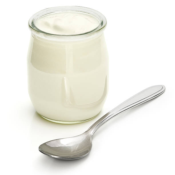 Yogurt A jar of plain yogurt with a silver spoon.  greek yogurt photos stock pictures, royalty-free photos & images