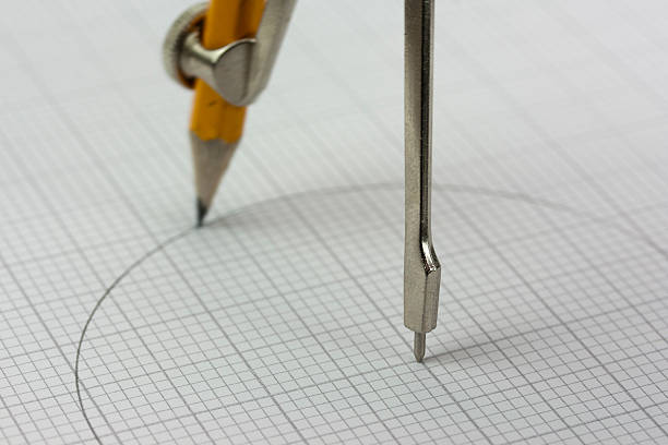 istock Close up of a compass on graph paper 519964376