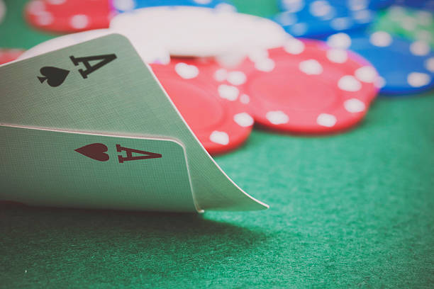 istock Poker chips and cards on a green table 519964998