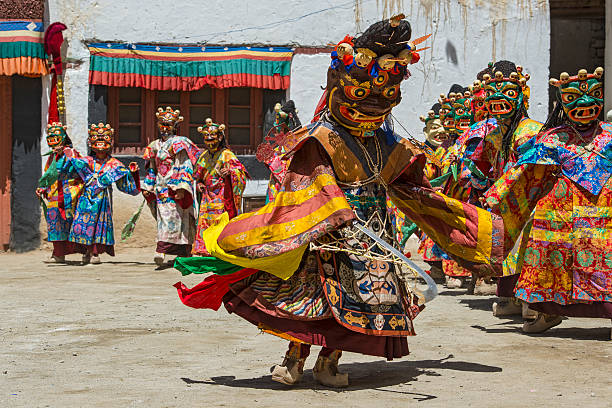 Buddhist monks are performing a sacred dance in Ladakh. Phyang, India - July 15, 2015: Buddhist monks are performing a sacred dance in the courtyard of Phyang Monastery, Ladakh. They are dressed in traditional costumes and are wearing masks. Phyang Monastery (Gompa) is a Buddhist monastery located in Phyang village, just 15 kilometres west of Leh in Ladakh, northern India. It was established in 1515.The monastery is one of only two in Ladakh belonging to the Drikung Kagyu school of buddhism. phyang monastery stock pictures, royalty-free photos & images