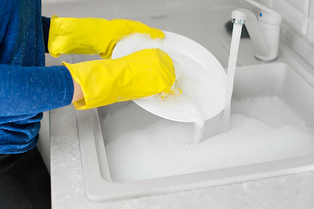 istock Closeup process of washing the white plate in sink 519966508
