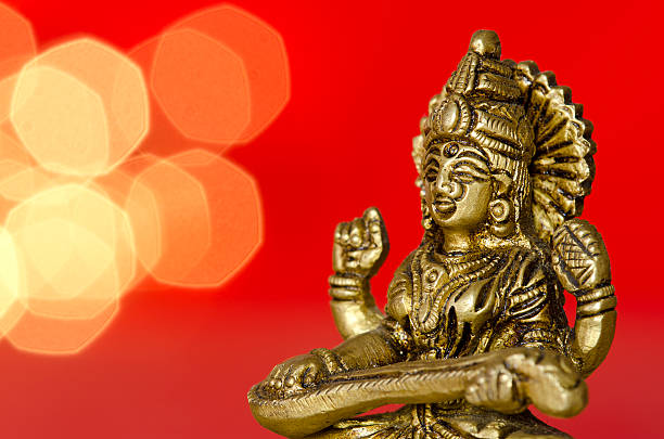 close up of a hindu deity statue on red background stock photo