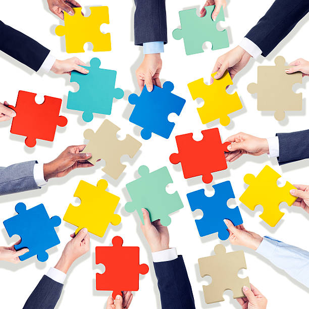 istock Group of Hands Holding Colourful Jigsaw Pieces 519971583
