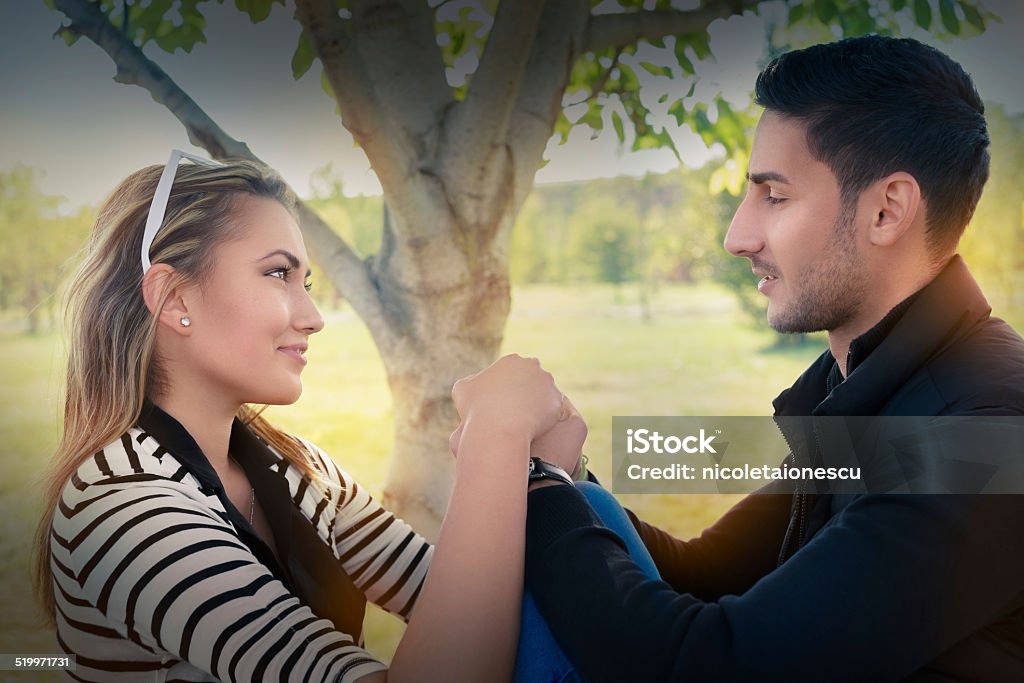 Young couple in love looking in each other’s eyes Romantic happy couple feeling flirty and holding hands Adult Stock Photo