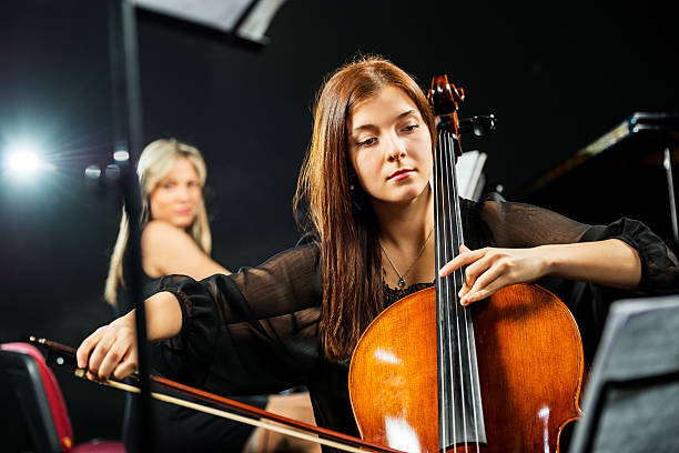 istock Young woman playing cello. 519974639
