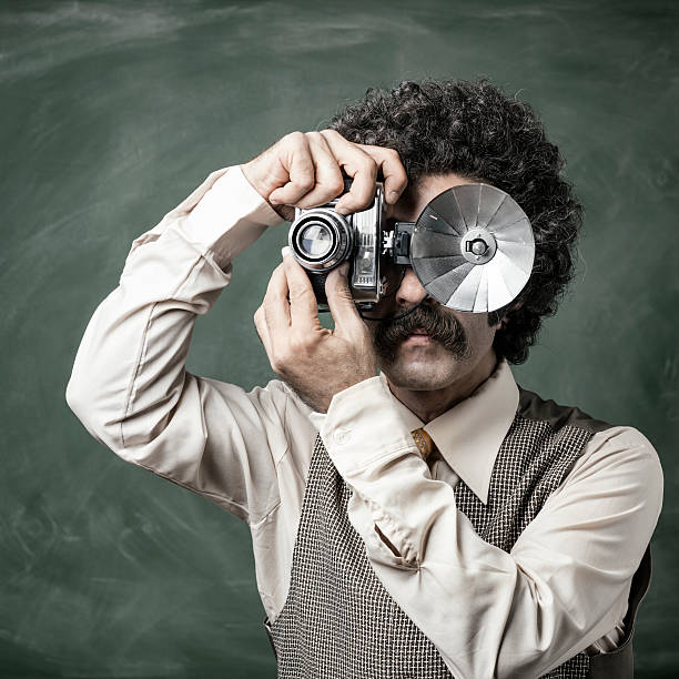 istock Mid adult man photographing via old fashioned camera 519976673