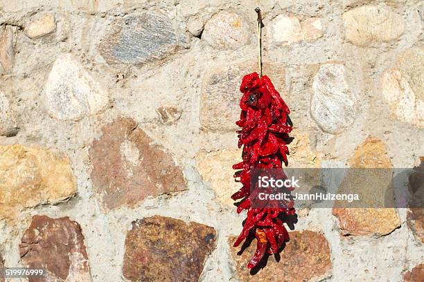 Red Chili Pepper Ristra Hangs On Stone Wall New Mexico Stock Photo - Download Image Now