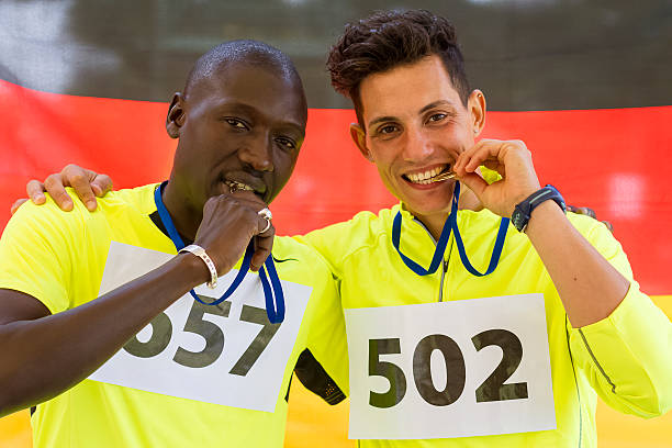 istock Athletes rejoicing with gold medals 519977489