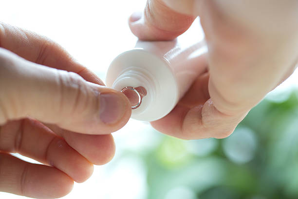 istock Two hands are unsealed bottle of cream. 519978009