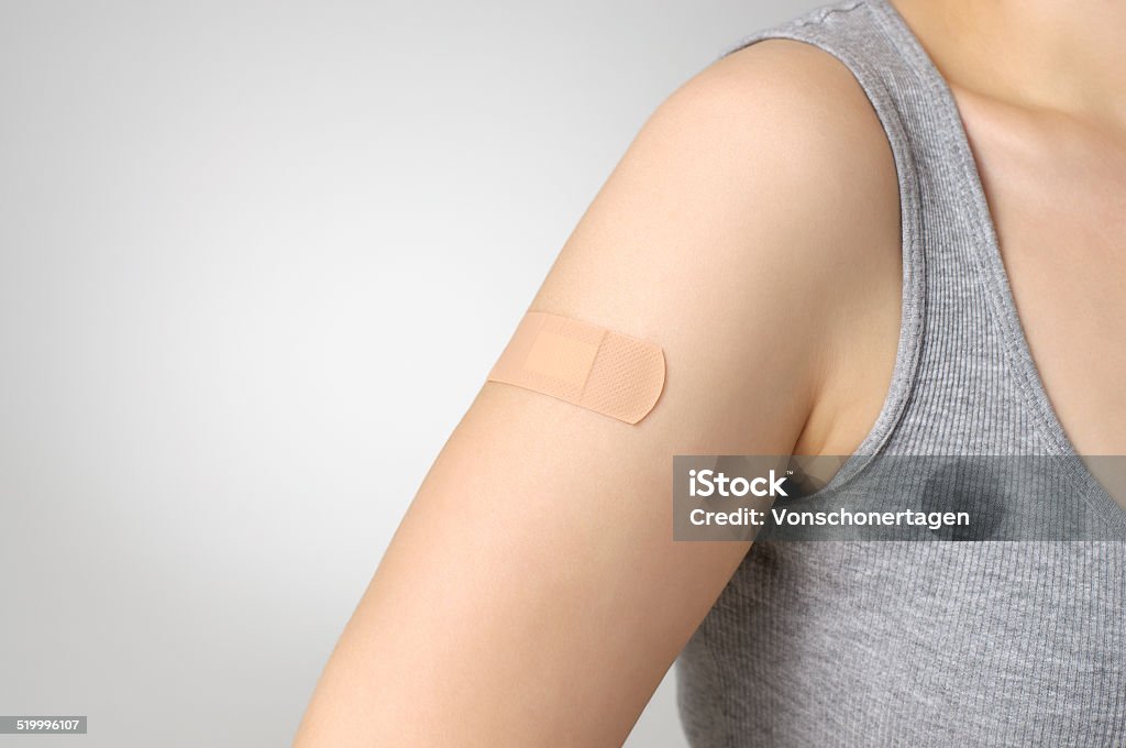 Plaster on female arm Female arm with adhesive bandage Adhesive Bandage Stock Photo