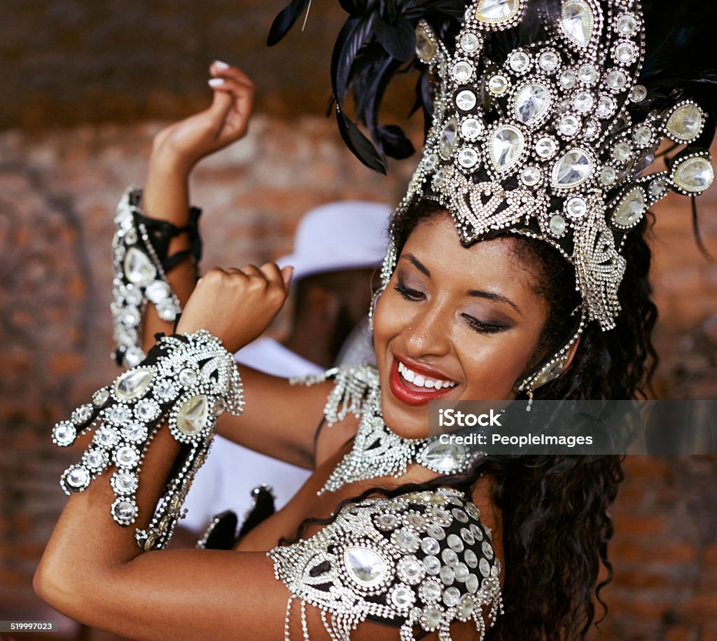 Take a little rhythm Shot of a beautiful samba dancer performing in a carnival with her band Adult Stock Photo