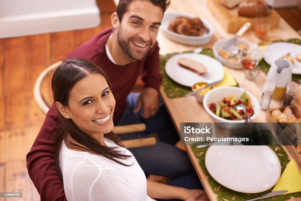 Love, food and good times A happy couple enjoying a family meal around the table 30-39 Years Stock Photo