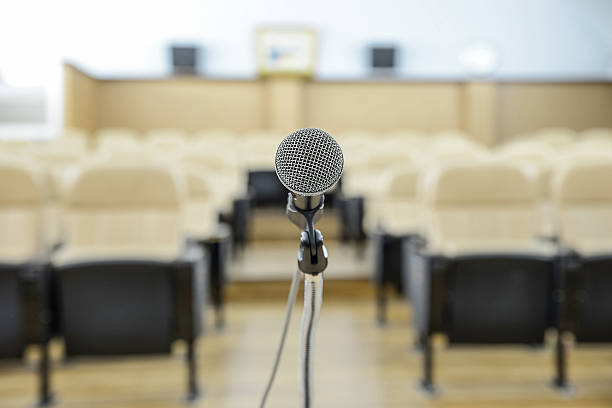 istock before a conference, the microphones in front of empty chairs. 519997611