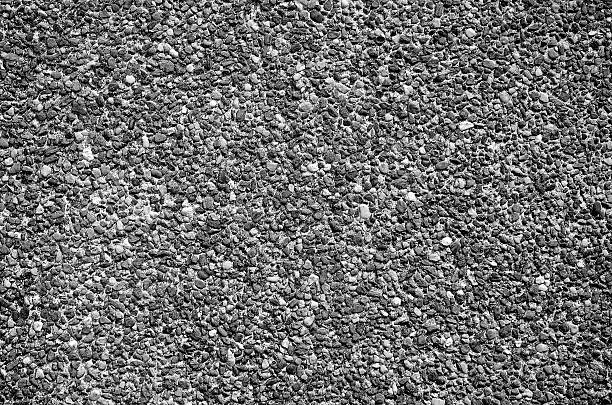 istock Black and white background of gravel wall texture 519997811