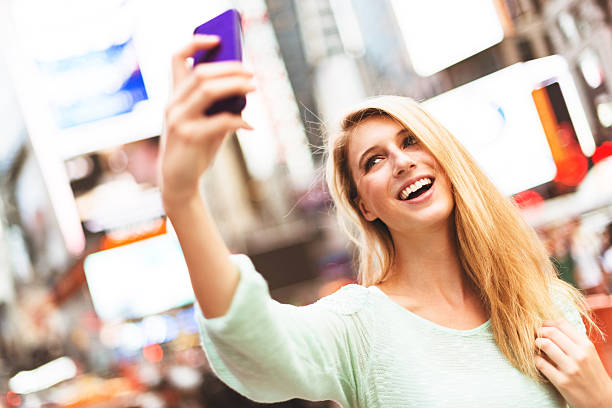 istock woman self photographing in times square - NYC 519997977