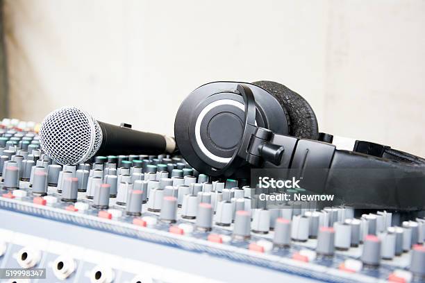 Microphone And Headphones On A Console Stock Photo - Download Image Now - Amplifier, Arts Culture and Entertainment, Audio Equipment