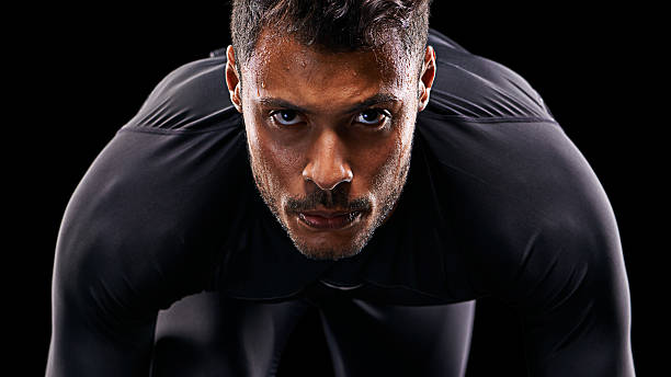Get ready Studio shot of a focussed athlete in the starting position spandex stock pictures, royalty-free photos & images