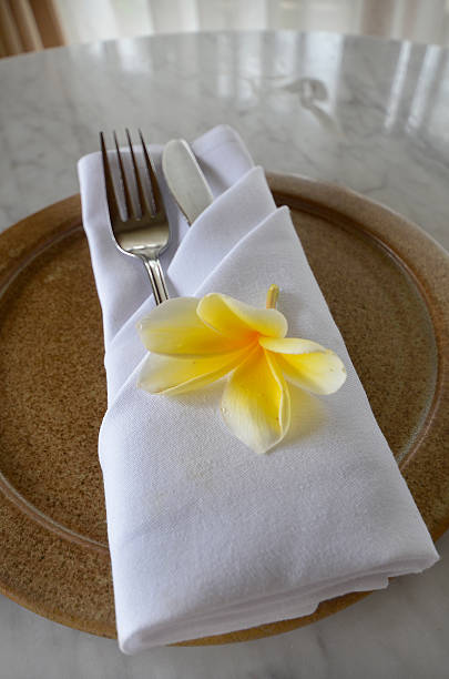 istock Plate with folded linen napkin knife and fork, lotus flower 519999247