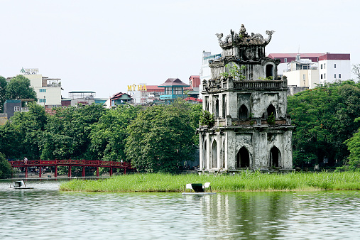 Ha Noi, Viet Nam - June 29, 2014: View of Turtle Tower on a small island on Hoan Kiem lake (known as Jade lake). This area is the center of Hanoi capital, Vietnam. Tortoise Tower is the symbol of Hanoi,Vietnam