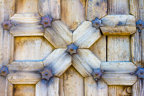 A detail from an ornate antique wooden Indian carved door.