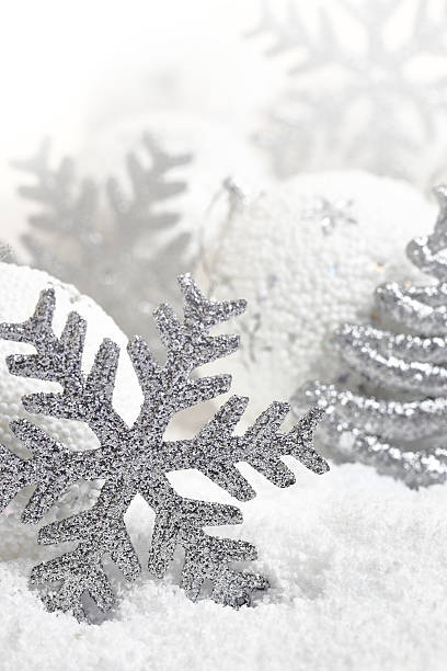 istock Christmas ornaments on white snowy background 520000769