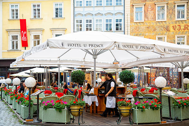 Prague, Czech Republic - September 28, 2014: People eating lunch at a street restaurant in the Old Town Square of Prague.