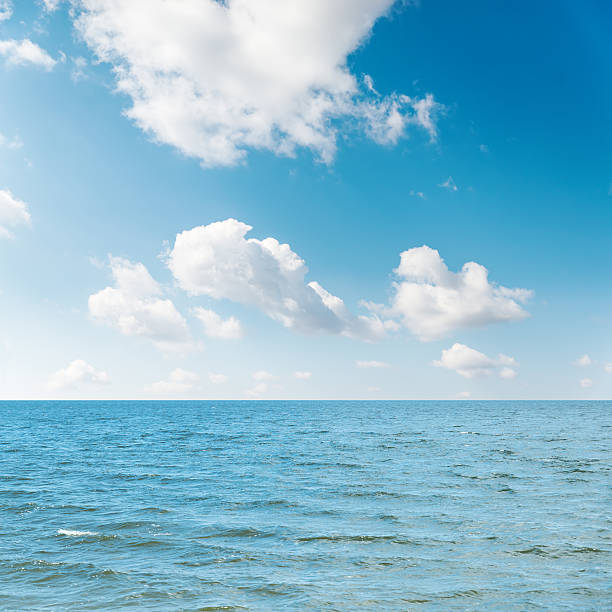istock waving sea and cloudy sky with sun over it 520001530