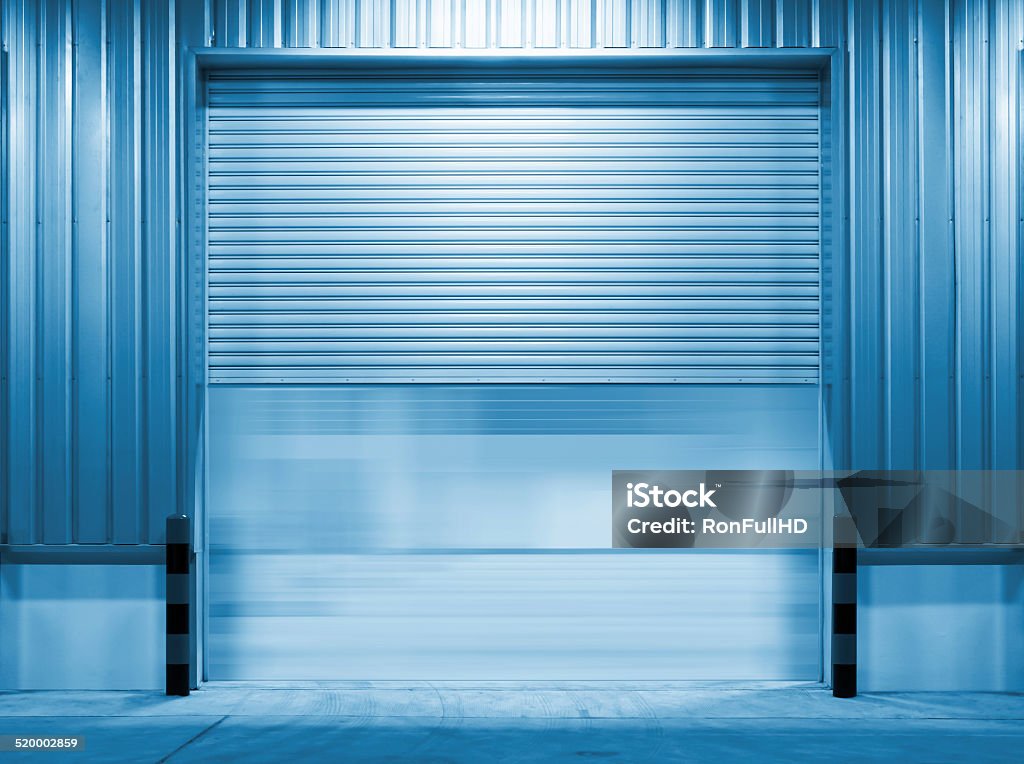 Shutter door Shutter door and steel door outside factory, blue color tone. Architecture Stock Photo