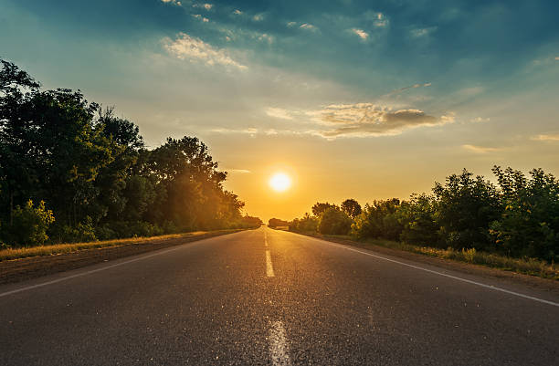 istock sun in horizon over asphalt road 520003404