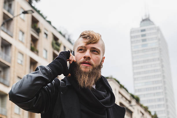 istock Stylish bearded man talking on phone 520006900
