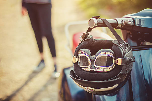 Old scooter with retro helmet on seat