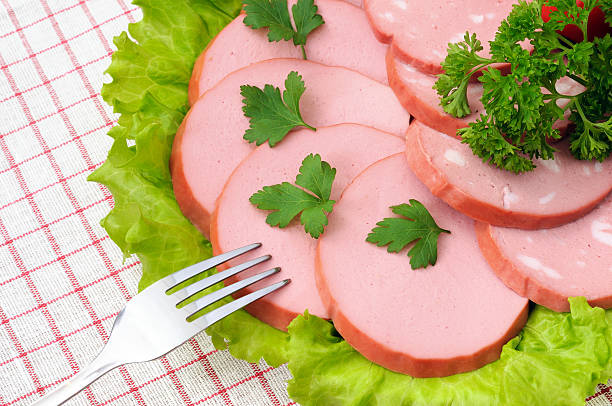 Fatias de salsicha, salada e salsa no prato - fotografia de stock