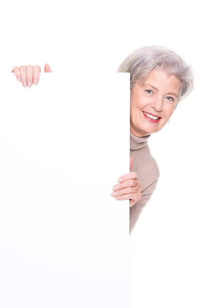 istock Senior woman with blank sign 520008520