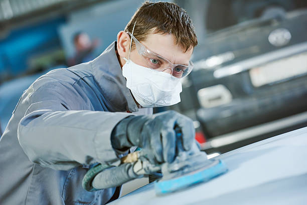 istock auto repairman grinding autobody bonnet 520009934