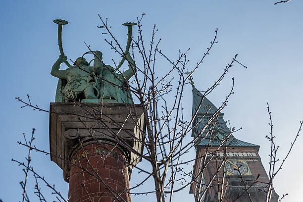 The lur players, Copenhagen, Denmark Copenhagen, Denmark - March 26, 2016: The two bronze lur players on a 20 m tall column next to the Town Hall tower, Copenhagen, Denmark. lur stock pictures, royalty-free photos & images