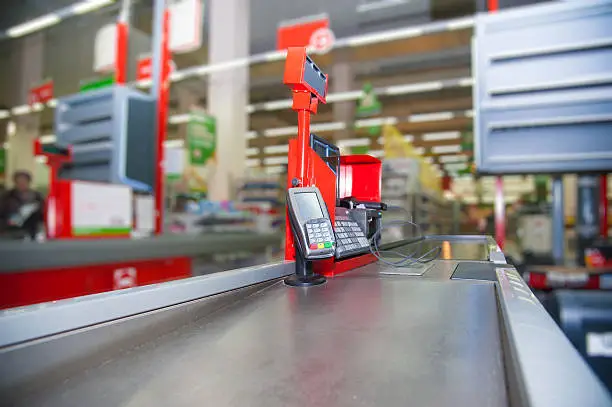 Photo of Cash desk with payment terminal in supermarket