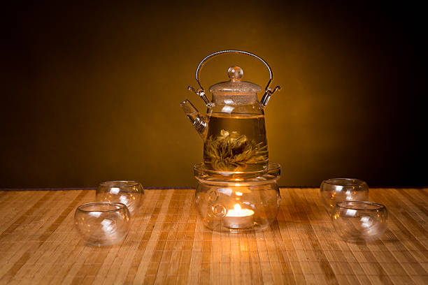 istock glass teapot with exotic green tea on wooden table 520017150